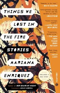A book cover for "things we lost in the fire: stories" by mariana enriquez, translated by megan mcdowell, featuring a striking design with flames and flora against a dark background, adorned with compelling reviews.