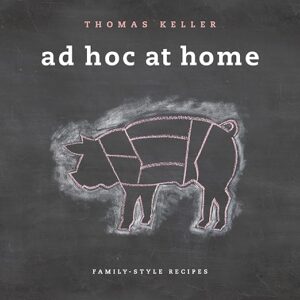 A chalk-style illustration of a pig divided into cuts of meat on a black background, with the text "thomas keller ad hoc at home" above and "family-style recipes" below.