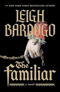 A conceptual book cover design for "the familiar" showing an upside-down hand with intricate symbols and a flower, suggesting elements of fantasy and mystique, authored by leigh bardugo.