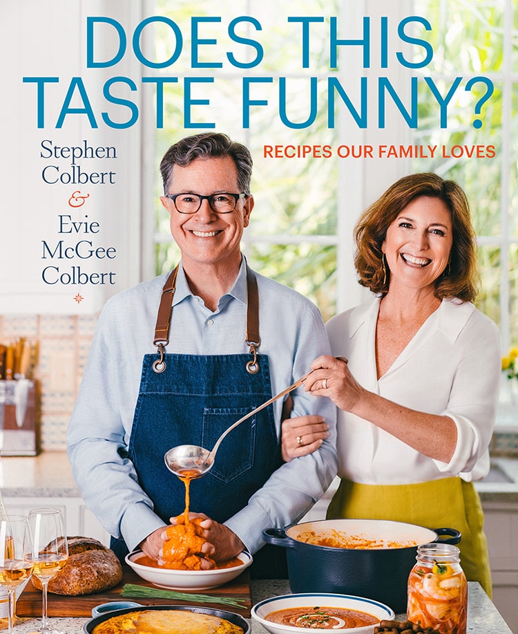 cover of stephen and evie's new cookbook, with evie pouring sauce all over stephen's hands