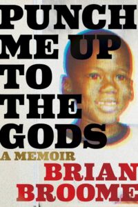 A bold book cover featuring the title "punch me up to the gods" in large, impactful letters with the subtitle "a memoir" and the author's name "brian broome" in a striking font overlaying a photograph of a young boy.