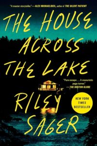 A suspenseful novel cover titled "the house across the lake" by riley sager, featuring a glowing house at night reflected in dark waters, with quotes praising the author's storytelling prowess.