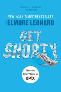 Promotional poster for the television adaptation of elmore leonard's "get shorty," featuring the title in large lettering with a playful graphic of a person being flipped by a filmstrip, highlighting the show's connection to the film industry and its action-comedy elements.