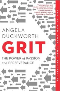 Cover of the book "grit" by angela duckworth, featuring the title and the author's name prominently in red and white, with a background pattern of gray arrows pointing upwards, symbolizing progress or advancement. the book is advertised as "the #1 new york times bestseller," and includes praise for its content from other authors at the top.