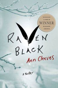 Book cover of "raven black" by ann cleeves, winner of the duncan lawrie dagger award, featuring a silhouette of a raven and bare tree branches against a misty grey backdrop, evoking a chilling thriller atmosphere.