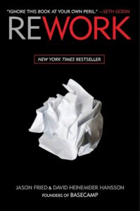 Rework - the revolutionary business book by jason fried & david heinemeier hansson, encouraging innovative thinking with a crumpled paper symbolizing old ideas being reshaped.