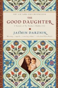 An ornate book cover for "the good daughter" by jasmin darznik, featuring floral motifs and a vintage photograph of a woman holding a child within a decorative medallion frame.