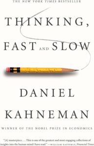 A yellow pencil with a slightly worn eraser traces a curving line above the title "thinking, fast and slow" by daniel kahneman, noted as a new york times bestseller and nobel prize winner, with a glowing review from the financial times at the bottom.