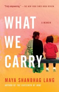 Two individuals seated side by side on a bench, overlooking a landscape, with the title "what we carry" by maya shanbhag lang – a tale of introspection and the silent stories we hold within.
