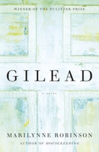 The cover of the pulitzer prize-winning novel "gilead" by marilynne robinson, featuring a simple, rustic wooden background with the title and author's name prominently displayed.