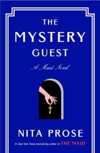 Book cover of "the mystery guest" by nita prose, featuring a dark arched doorway with a hand holding a key, set against a blue background with white and yellow text.