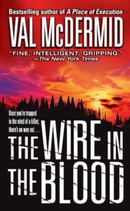 Book cover of 'the wire in the blood' by val mcdermid, featuring a silhouette of a forest against a blood-red sky, teasing a thrilling and suspenseful read.