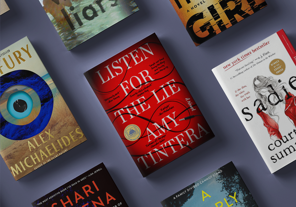 A flat lay photo showcasing a collection of books arranged on a purple background. Prominent titles include "Listen For The Lie" by Amy Tintera, "Sadie" by Courtney Summers, "The Silent Patient" by Alex Michaelides, and "Little Fires Everywhere" by Celeste Ng.