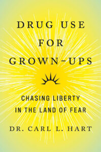 Book cover of "Drug Use for Grown-Ups: Chasing Liberty in the Land of Fear" by Dr. Carl L. Hart. The cover features a radiant sunburst design with title text in black on a yellow and green gradient background.