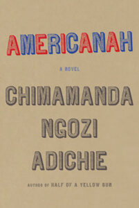 Book cover of "Americanah" by Chimamanda Ngozi Adichie with the title in red and blue on a beige background.