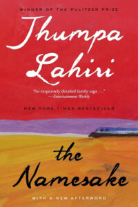 Book cover of "The Namesake" by Jhumpa Lahiri, featuring red and yellow landscapes with text highlighting awards and reviews.