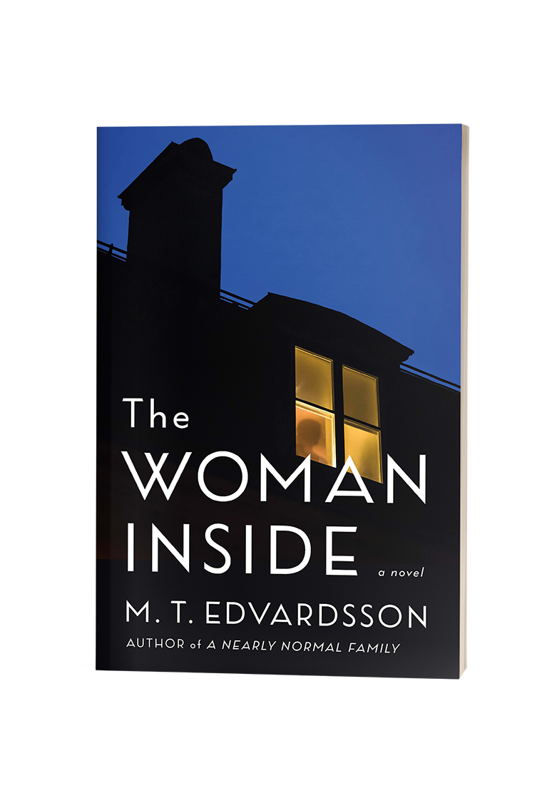 Book cover of "The Woman Inside" by M.T. Edvardsson, featuring a lit window in a dark house against a blue sky.