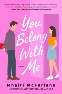 Cover of "You Belong With Me" by Mhairi McFarlane. A man with flowers faces a woman by a pink door.