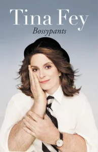 Woman in a shirt and tie with her head resting on her hand, which has a man's arm. Text reads "Tina Fey Bossypants".