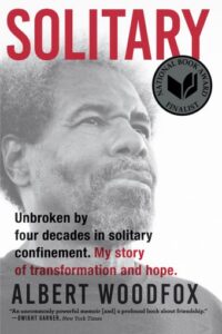 Cover of the book "Solitary" by Albert Woodfox, featuring a close-up of the author's face and the National Book Award Finalist seal.