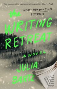 Book cover of "The Writing Retreat" by Julia Bartz, featuring snowy trees and a book with turning pages.