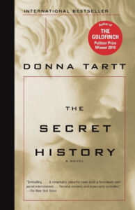 The Secret History" book cover by Donna Tartt, featuring a statue and award sticker.