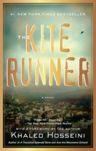 Cover of "The Kite Runner" by Khaled Hosseini, featuring a cityscape and sky with large, bold title text.