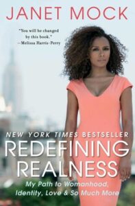 Cover of "Redefining Realness" by Janet Mock with her standing in an orange top against a cityscape background.