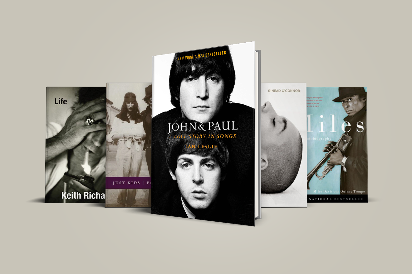 Five autobiography book covers standing upright, with "John & Paul" book featured in the center.