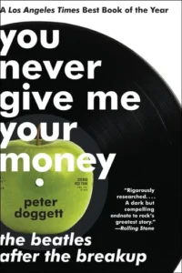 Book cover with a vinyl record and green apple. Title: 'You Never Give Me Your Money.' Author: Peter Doggett.