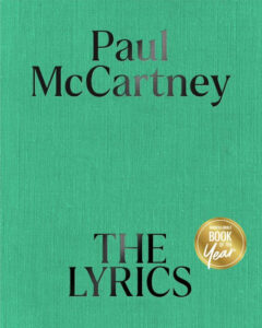 Green book cover titled "Paul McCartney: The Lyrics," with a "Book of the Year" badge.