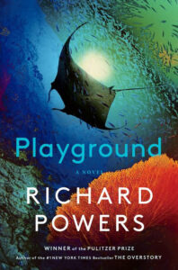 A manta ray swims above coral reefs on the cover of "Playground" by Richard Powers.