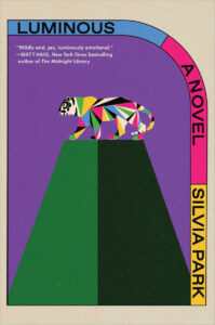 A geometric, multicolored tiger stands atop a green platform on the cover of "Luminous" by Silvia Park.