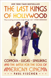 Three men in 1970s clothing pose together on the cover of "The Last Kings of Hollywood" by Paul Fischer.