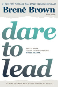 Book cover of "Dare to Lead" by Brené Brown with bold teal and gray gradient text and white background.