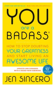 Yellow book cover of "You Are a Badass" by Jen Sincero with bold black and blue text.