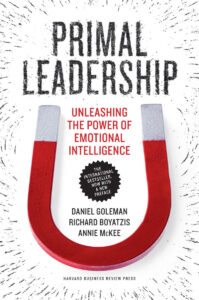 Book cover of "Primal Leadership" with a red horseshoe magnet and bold black and red text.