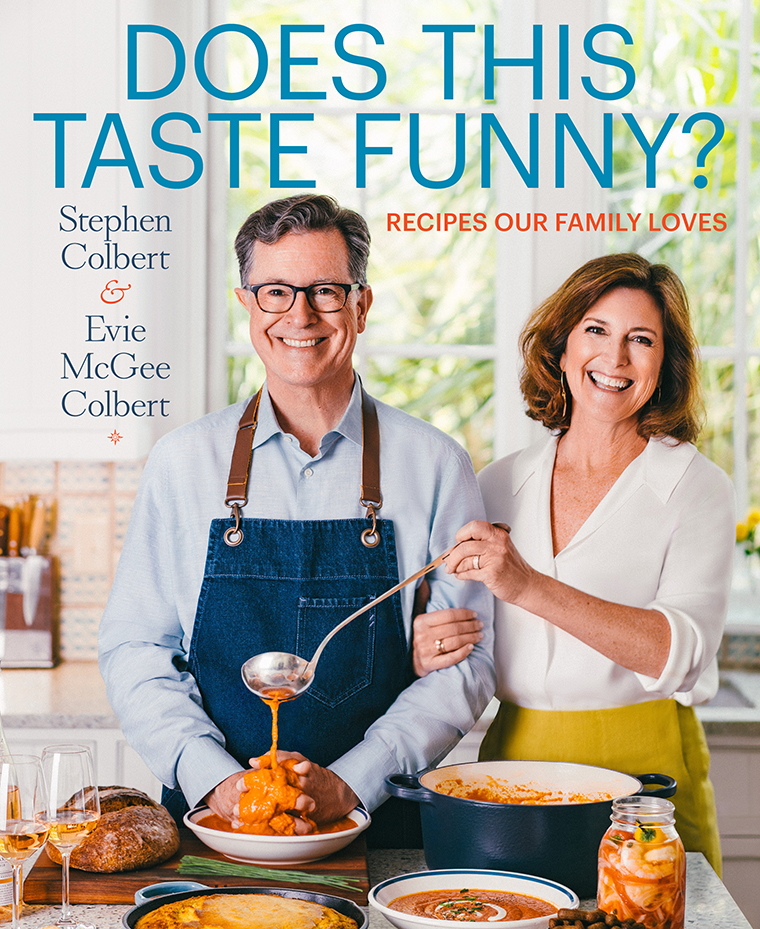 Stephen Colbert and Evie McGee Colbert serving soup in a bright kitchen, surrounded by dishes and drinks.