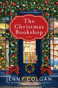 A bookshop decorated with Christmas wreaths and lights; "The Christmas Bookshop" by Jenny Colgan is displayed.