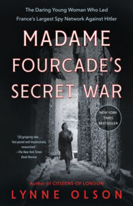 A woman walks down a narrow, old stone alley; the book title "Madame Fourcade's Secret War" is overlaid in red text.