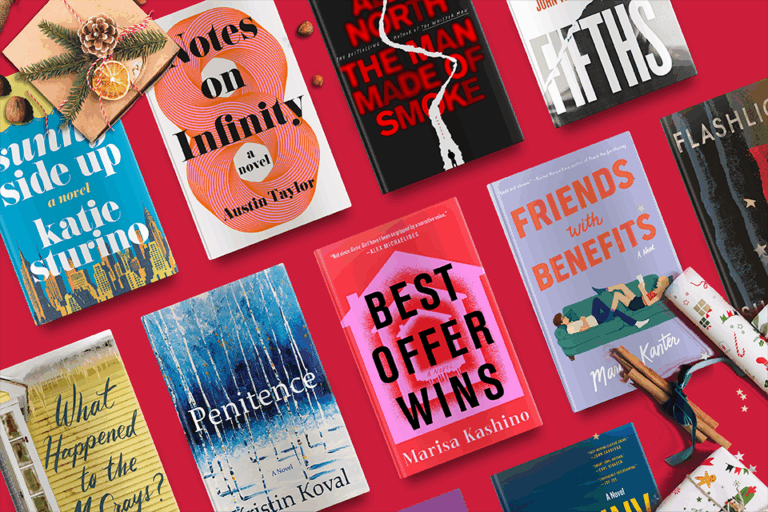 A variety of colorful book covers arranged on a red surface with festive holiday decorations.