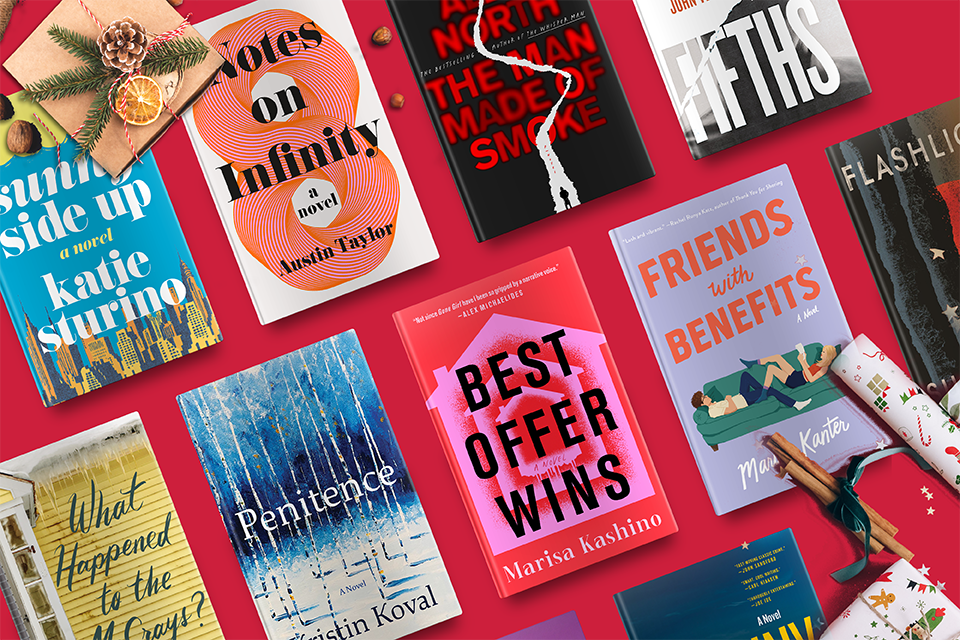 A variety of colorful book covers arranged on a red surface with festive holiday decorations.