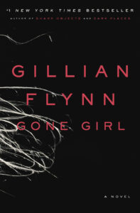 Book cover for "Gone Girl" by Gillian Flynn with pink text on a black background and white strands in the corner.
