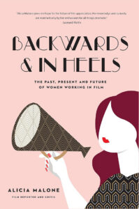 Book cover for "Backwards & In Heels" with a stylized woman holding a megaphone on a pink background.