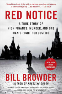 A person walks across Red Square toward the Kremlin; the book cover reads "Red Notice" by Bill Browder.