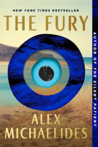 Book cover for "The Fury" by Alex Michaelides, featuring a blue eye design over a beach landscape.