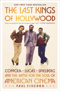 Three men in 1970s fashion pose on the book cover for "The Last Kings of Hollywood" by Paul Fischer.
