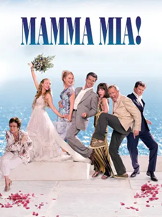 Six people pose playfully in front of the sea under the title “Mamma Mia!” above them.