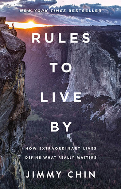 Book cover for Rules to Live By by Jimmy Chin, featuring a person standing on a mountain cliff at sunset.