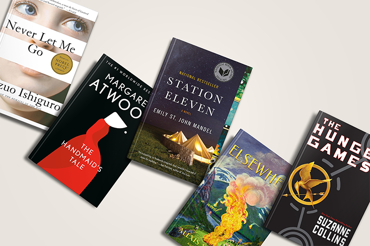 Five popular dystopian novels arranged in a scatter on a light surface, showing their colorful covers.